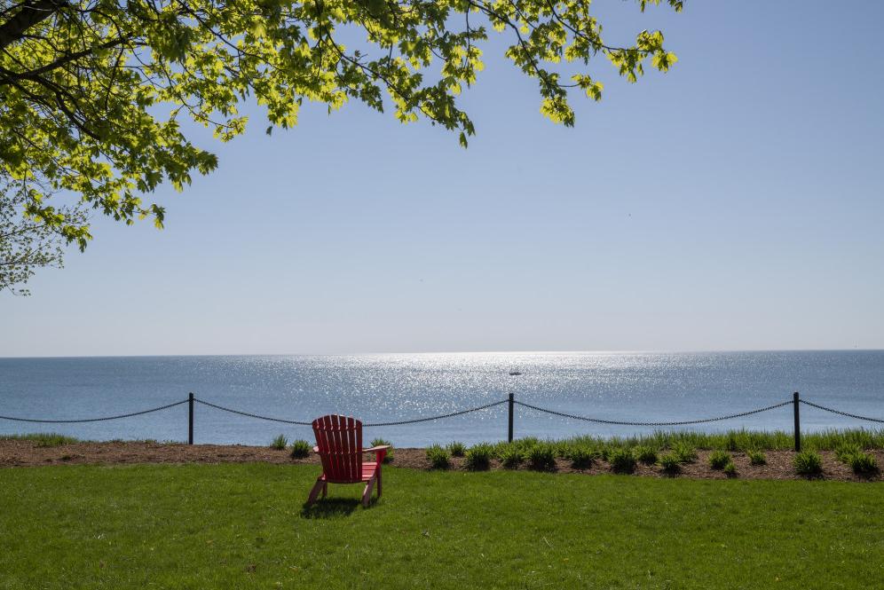 A red chair looks out to Lake Michigan.