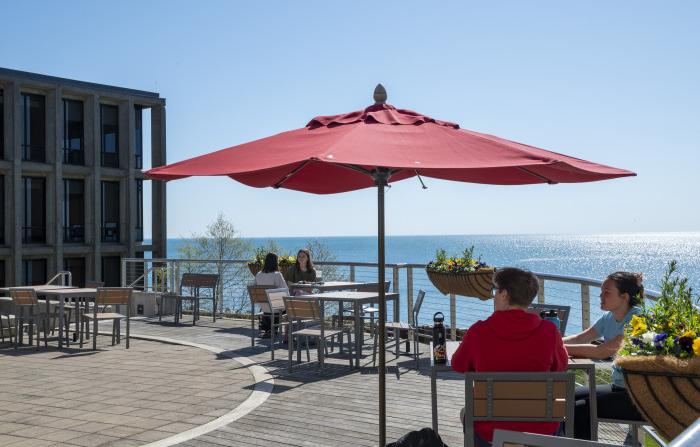 Students sit outside on the Hamar Patio.