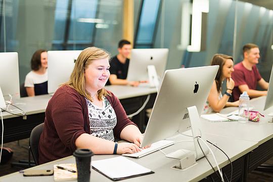 Students work on computers in the Mac Lab in Hedberg Library.